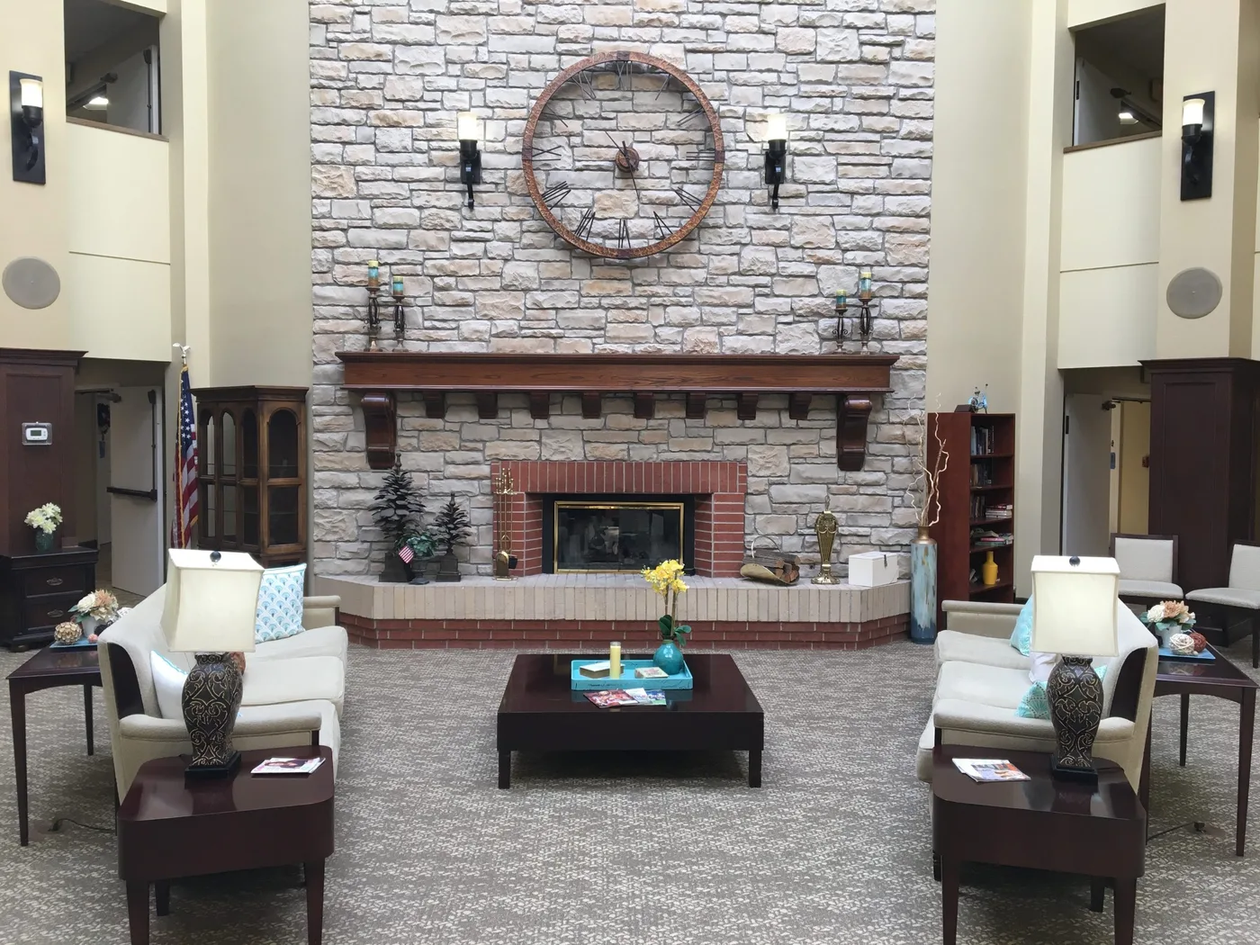 Senior living common area with new patterned flooring around a stone fireplace